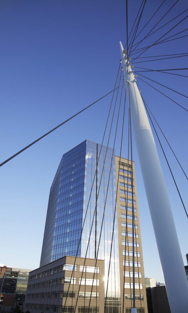 A Denver modern building and section of a suspension bridge.